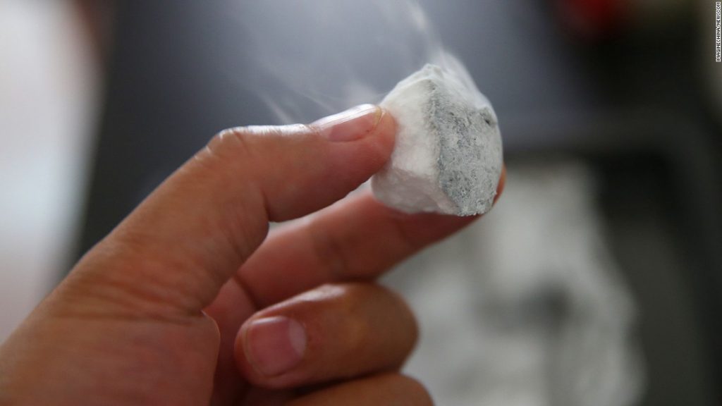 تکه ای از یخ آتشین در دست دانشمندی ژاپنی - این تکه از اعماق دریای ژاپن و در شمال دریای چین بدست آمده است.